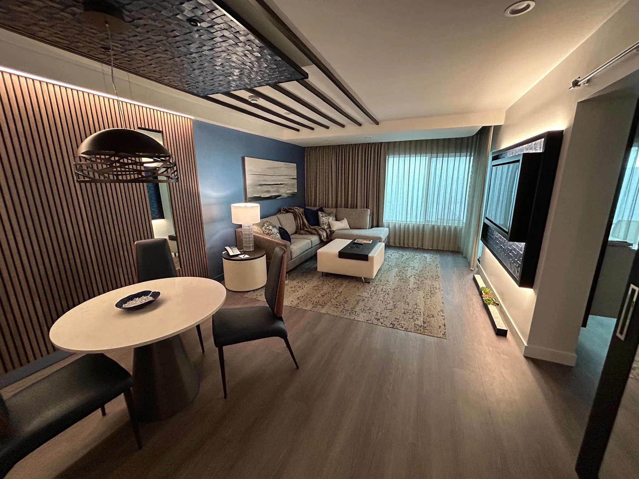 Finished Sunset Marquis suite with wood-look plank flooring, dining nook and seating area