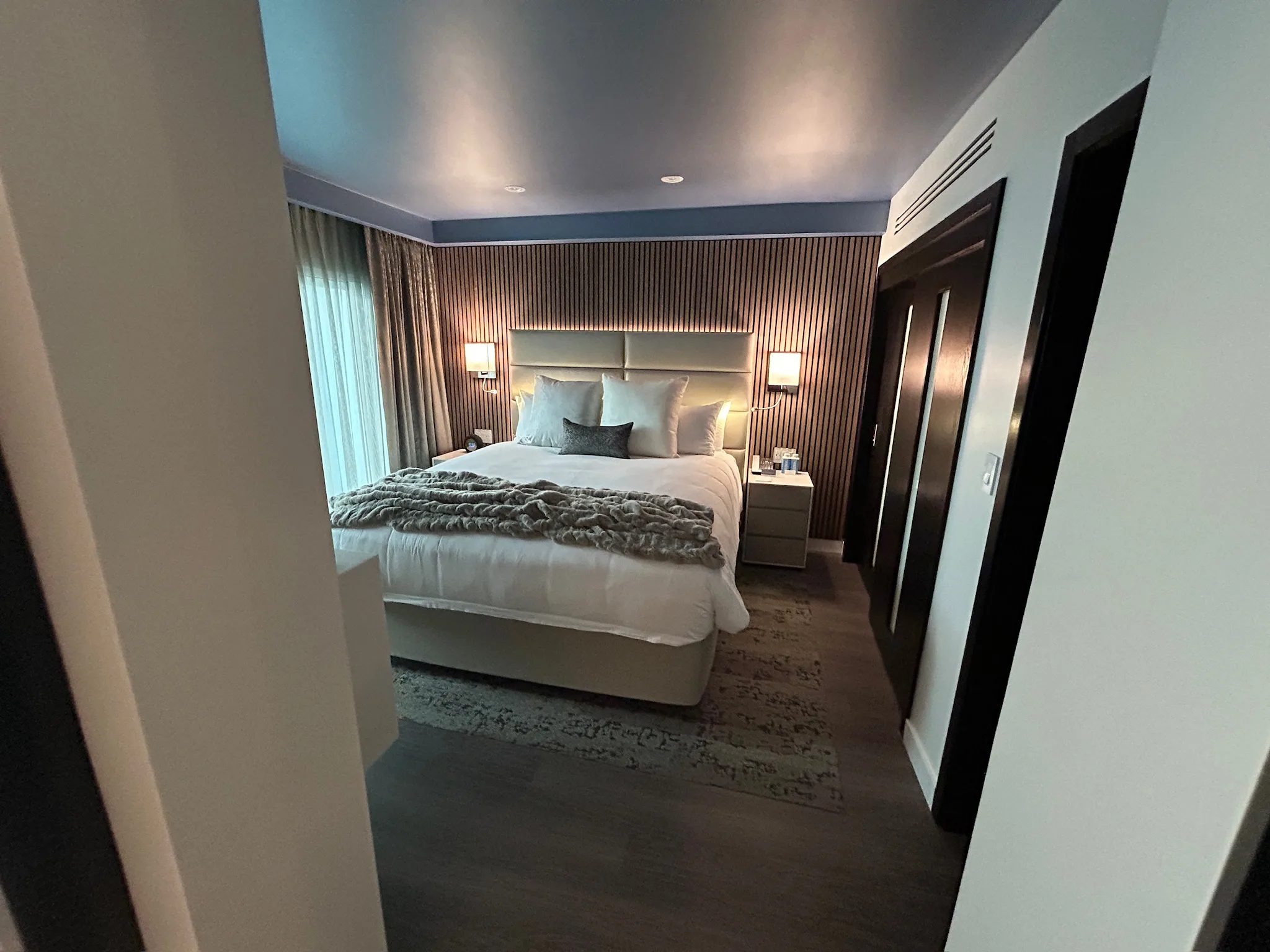 Sunset Marquis guest bedroom seen from the doorway, plank floor underfoot