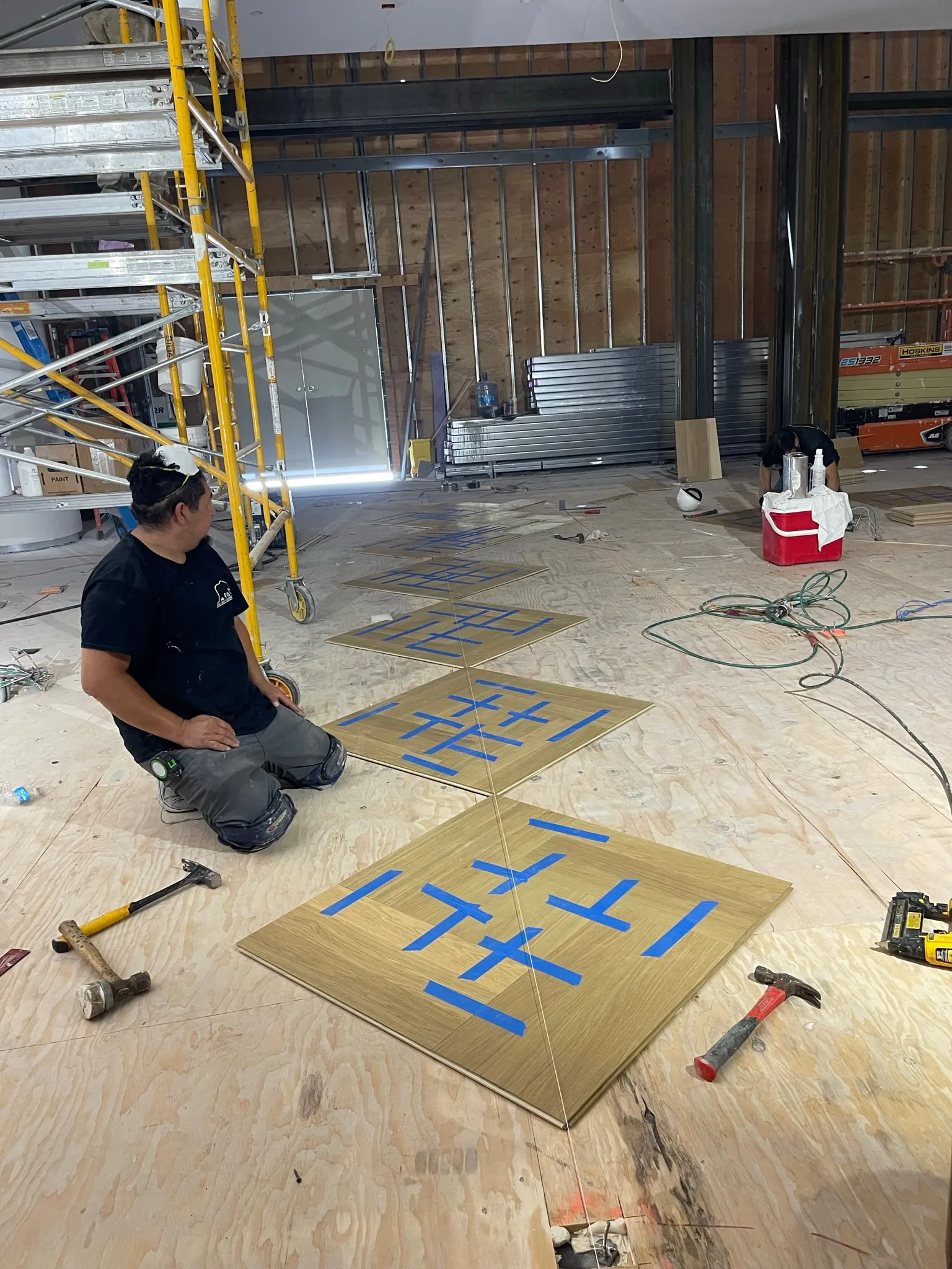Taped oak parquet panels staged for installation at Tiffany & Co. Glendale