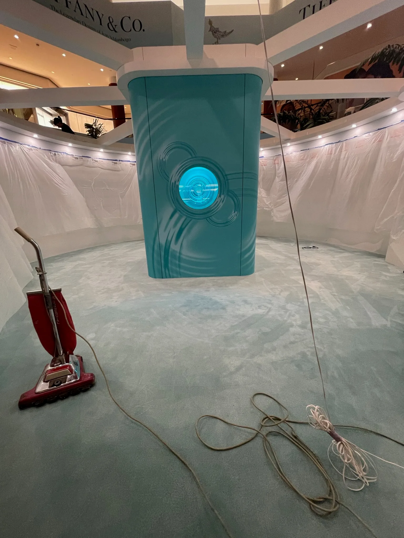 Final vacuum of the new Tiffany-blue carpet around the pavilion's teal centerpiece, South Coast Plaza