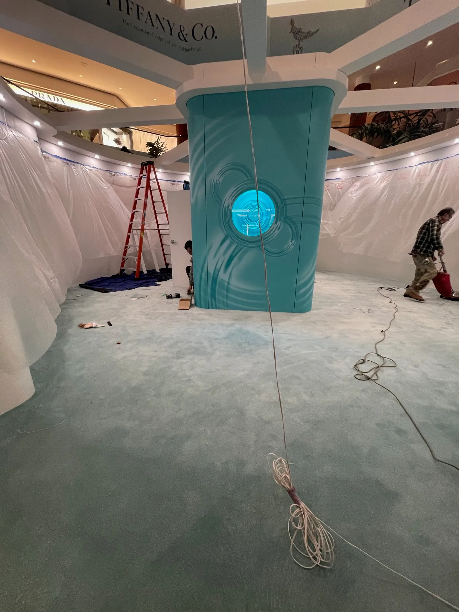 Cal Coast Flooring installer finishing the carpet edge inside the Tiffany & Co. pop-up pavilion