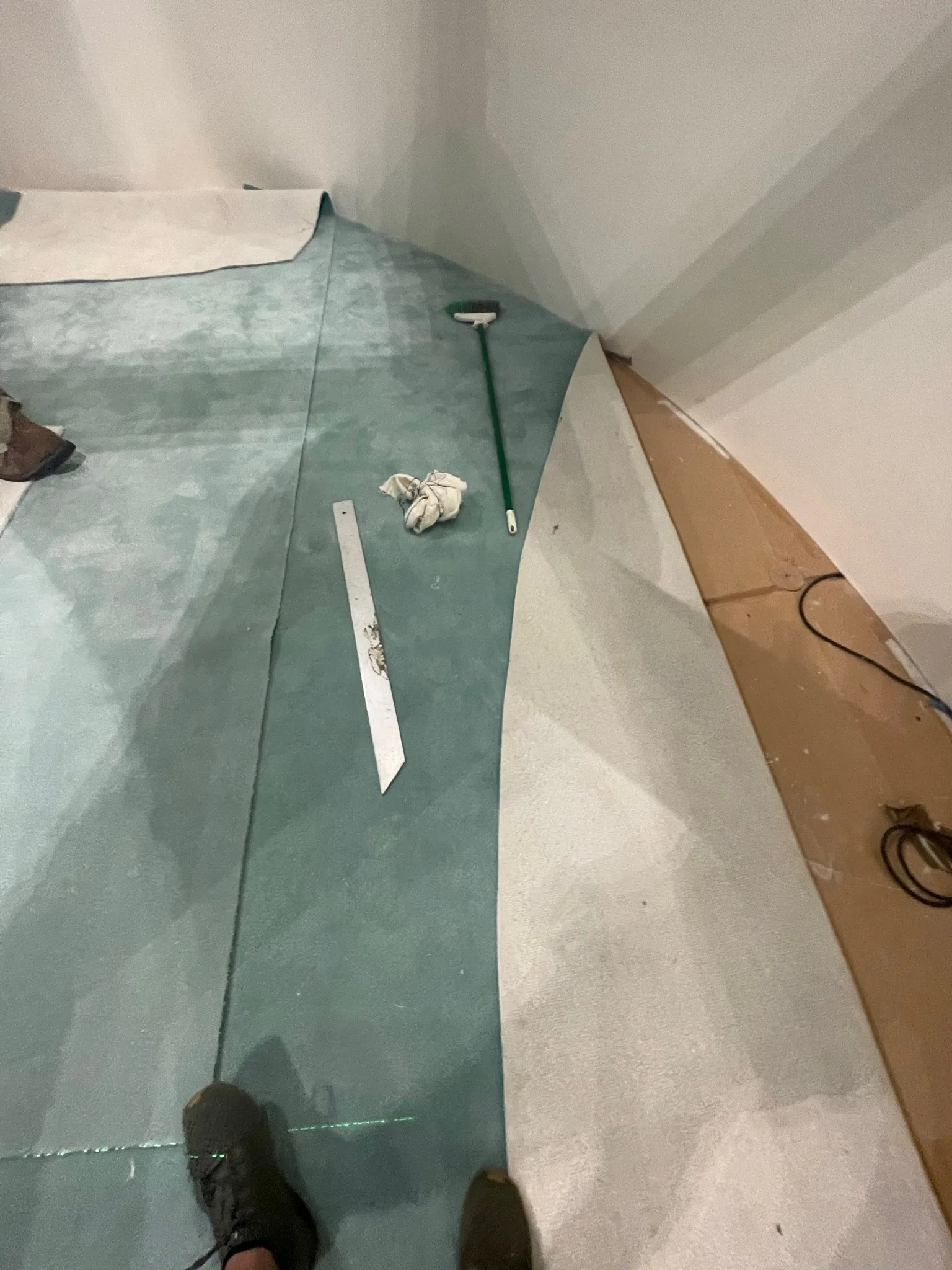 Fitting the custom carpet along the curved pavilion wall during the overnight install