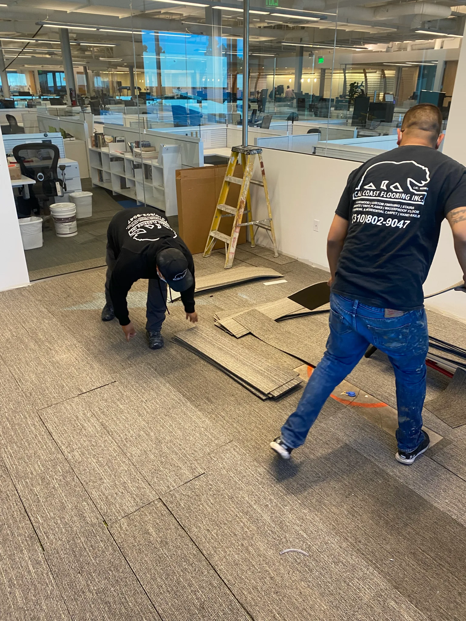 Cal Coast Flooring crew laying carpet tile across an open-plan office at the Wedgewood building
