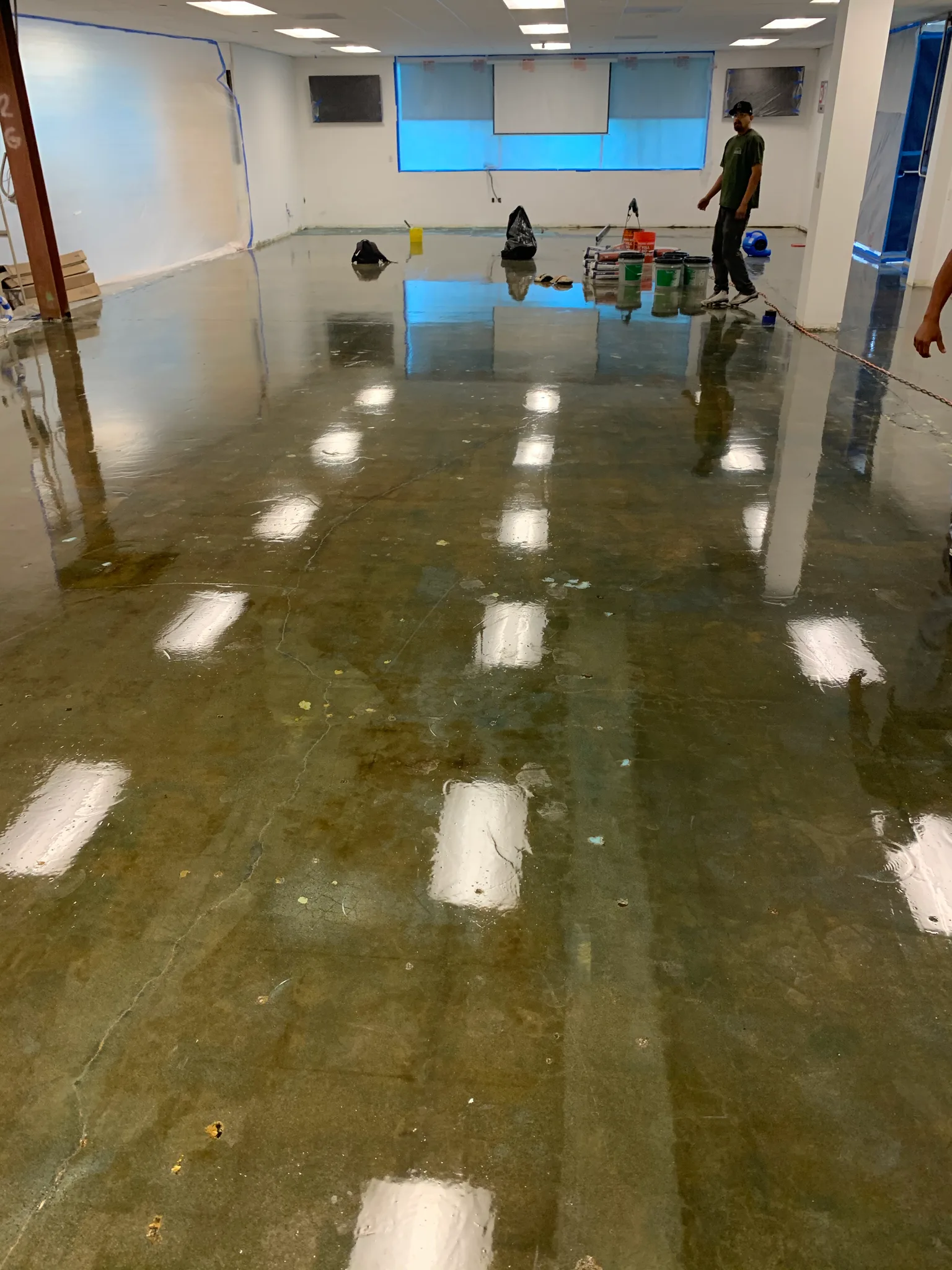 Cured moisture barrier across a large slab at Wedgewood, crack repairs filled ahead of the new floor