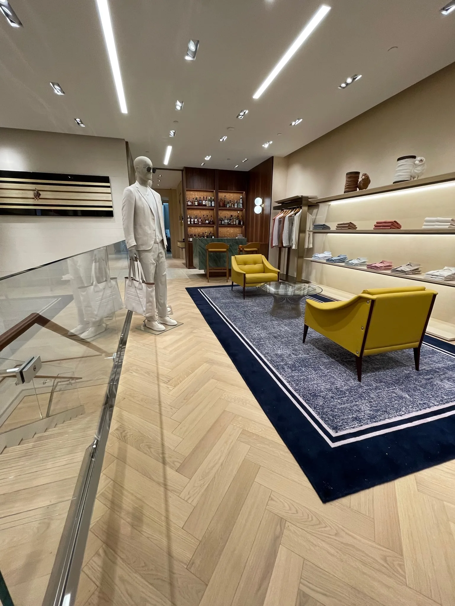 Herringbone oak flooring through the upper-level lounge and bar at Zegna Beverly Hills