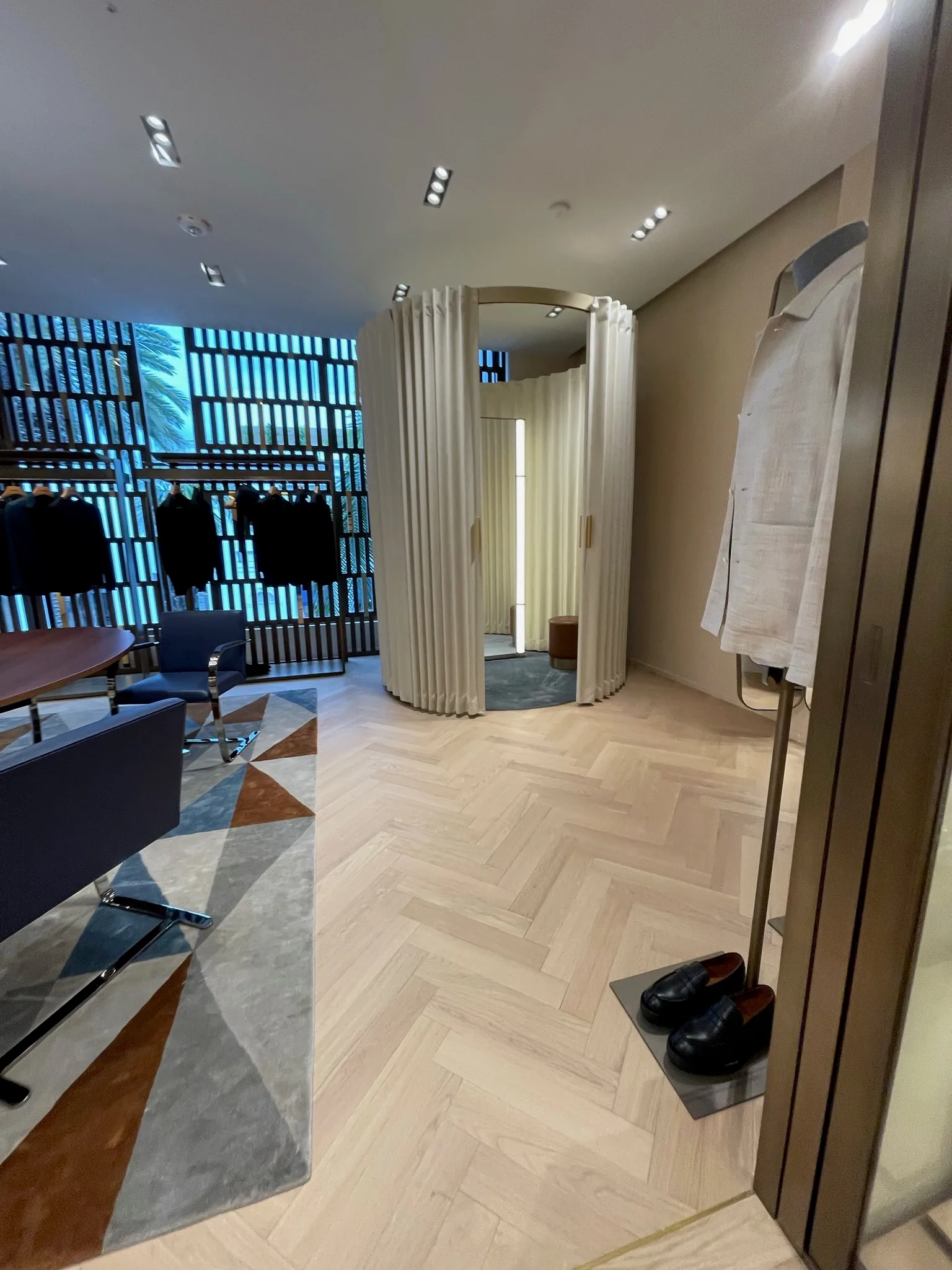 Oak herringbone flooring outside the curved fitting rooms at Zegna Beverly Hills