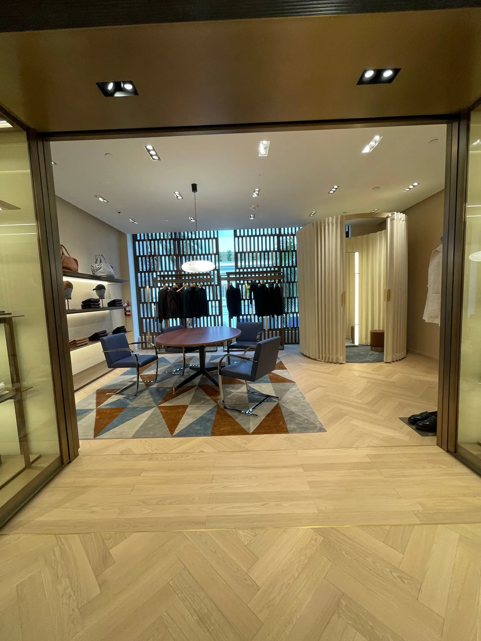 Herringbone oak floor and geometric rug by the fitting rooms at Zegna Beverly Hills
