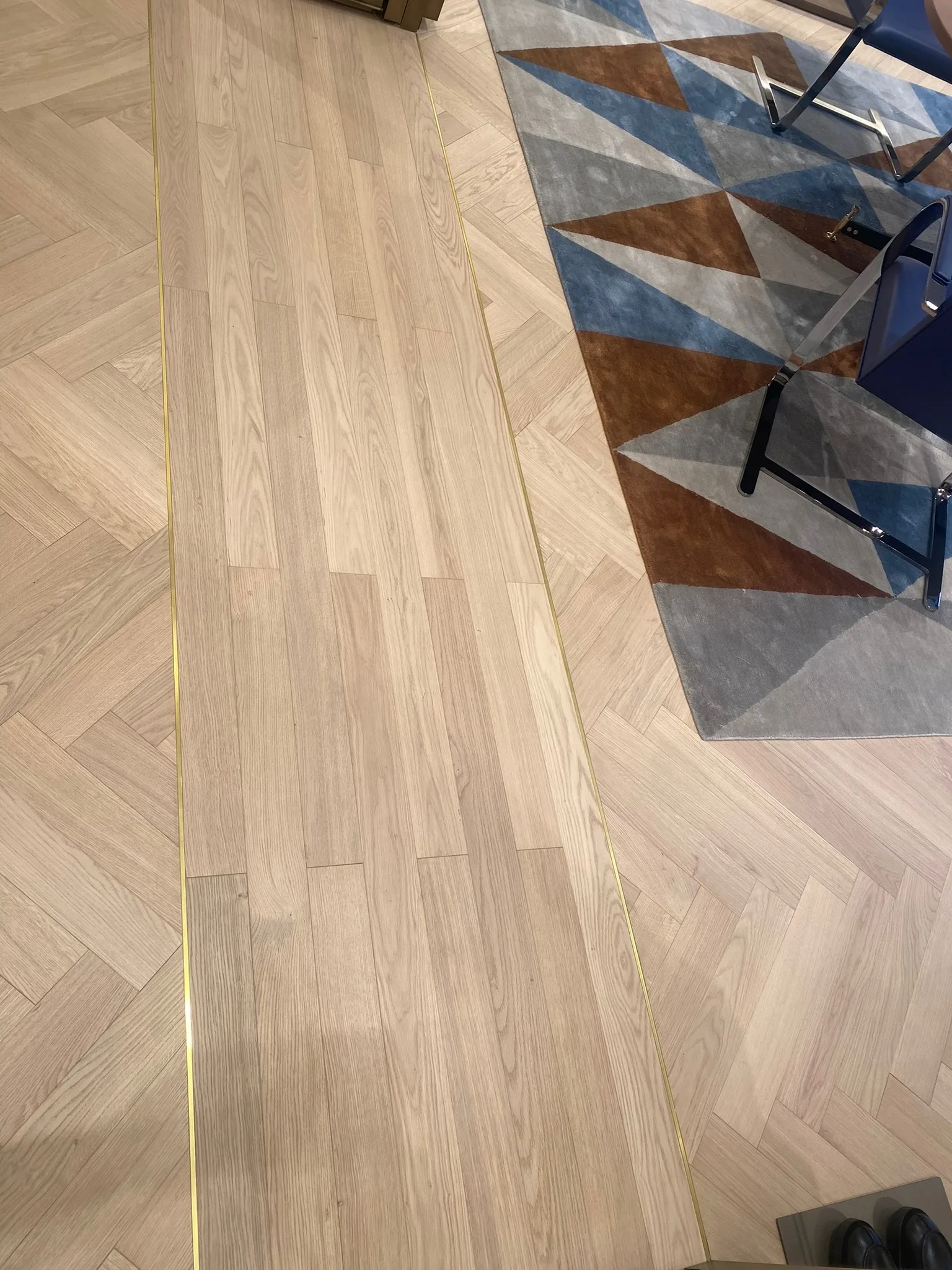 Metal transition strip set flush into the prefinished oak floor at the Zegna Beverly Hills store