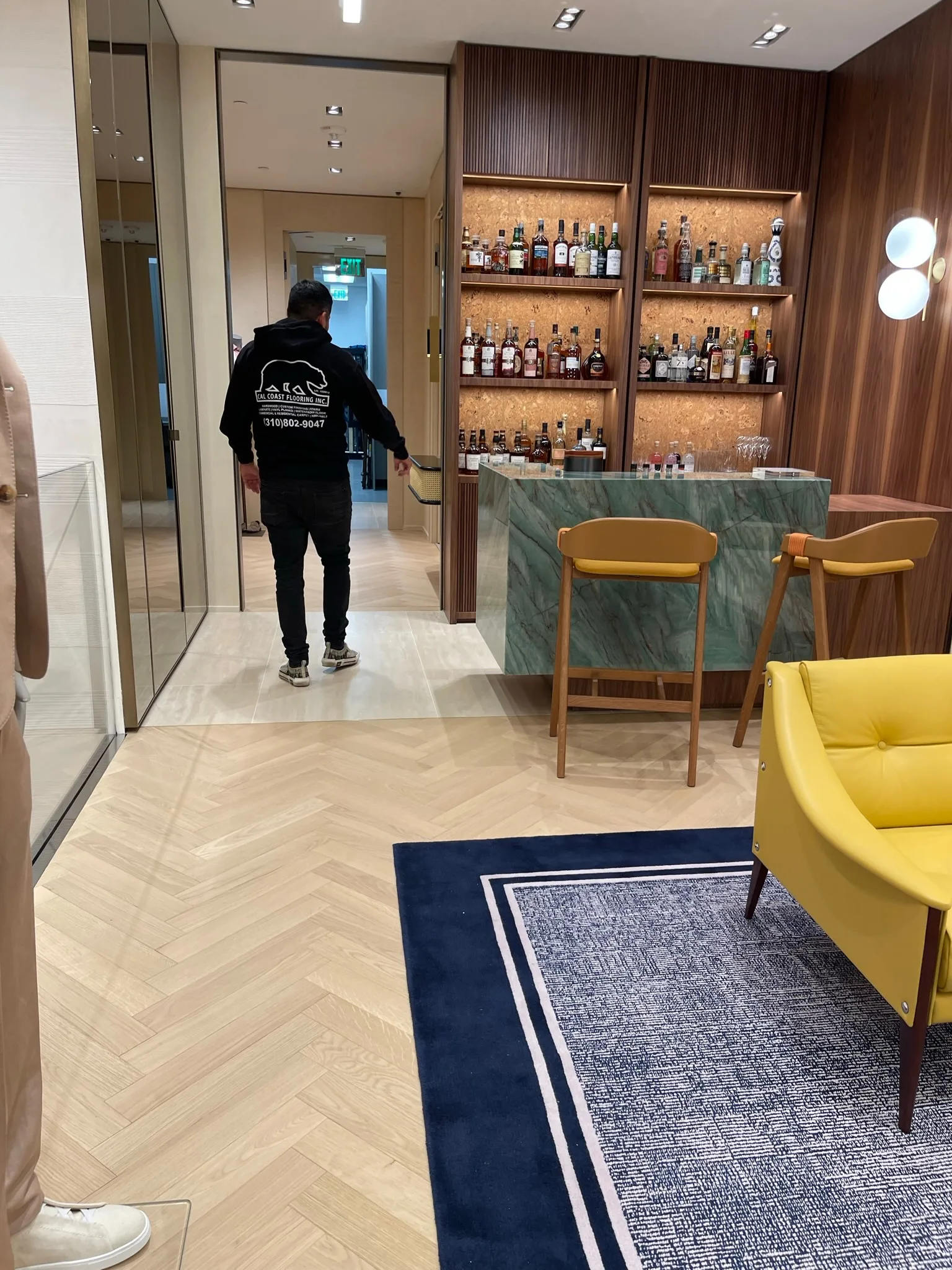 Cal Coast Flooring crew member crossing the completed herringbone floor at Zegna Beverly Hills